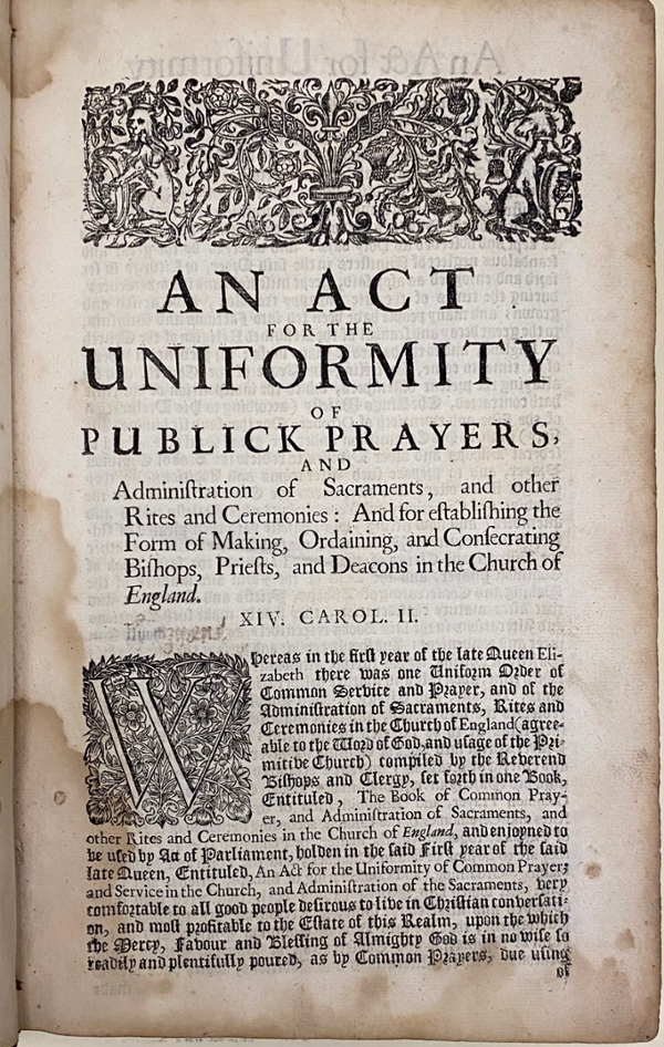 Original 1662 BCP, first page of the “Act for the Uniformity of Publick Prayers.” There is a black-and-white decoration at the top of the page, which includes a depiction of the Scottish thistle joined with the rose of England, with the French fleur-de-lis between them. The first letter in the page text is an ornate upper-case “W”. The book is held at the Cushing Memorial Library and Archives.