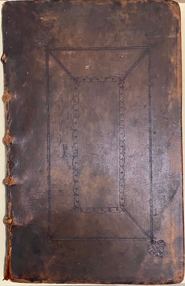 Cover of the original 1662 Book of Common Prayer (BCP). The cover is made of worn dark-brown leather and has a geometrical decoration on it. The book is held at the Cushing Memorial Library and Archives.